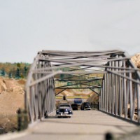 Looking through highway bridge to train