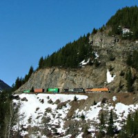 A stack train climbing east approaching the twin sheds