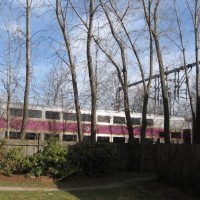Bi_Level_Commuter_Car_over_the_fence_and_thorugh_the_trees