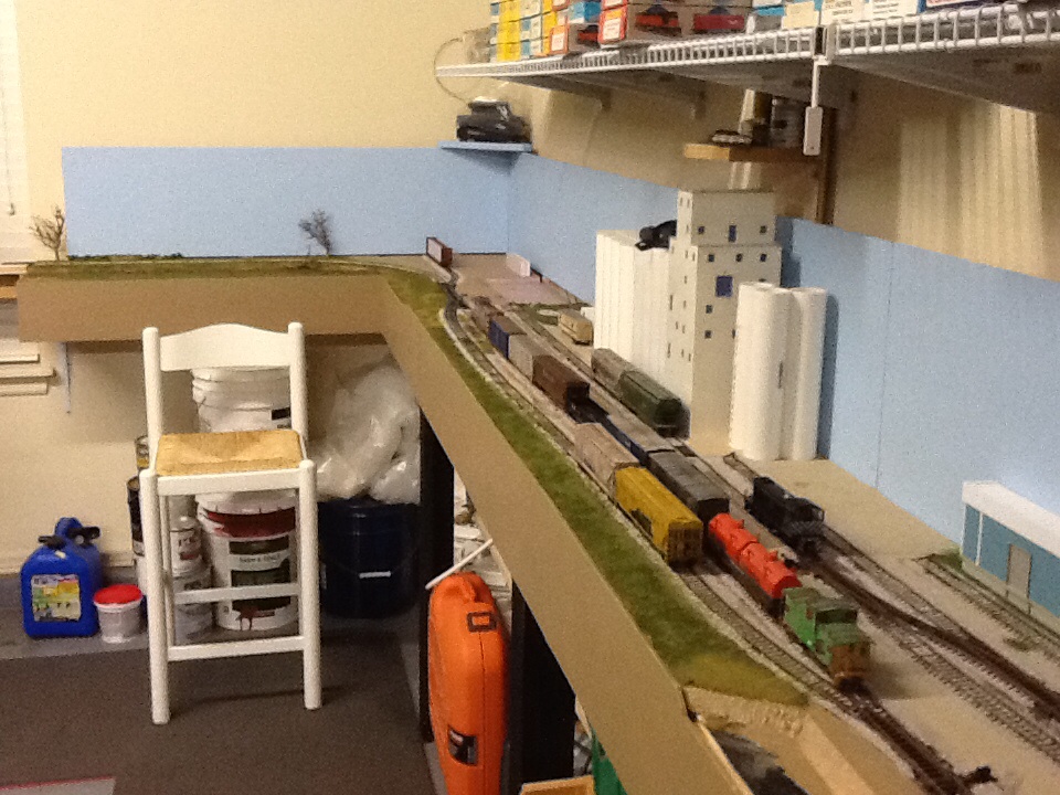 Looking East towards BNSF interchange. I am adding shelving over the layout. This will also serve to support the upper valance. It will be painted to match the blue back board. I will also paint the wall above the sky board to match. At some point I add lighting behind.