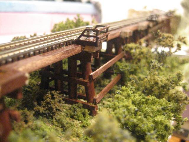 Wooden trestle close-up on details. It's Micro Engineering Bridge flex track complete with guard rails and little platforms. It think I did a good job (for a first try ever) but I won't claim a medal for this one.